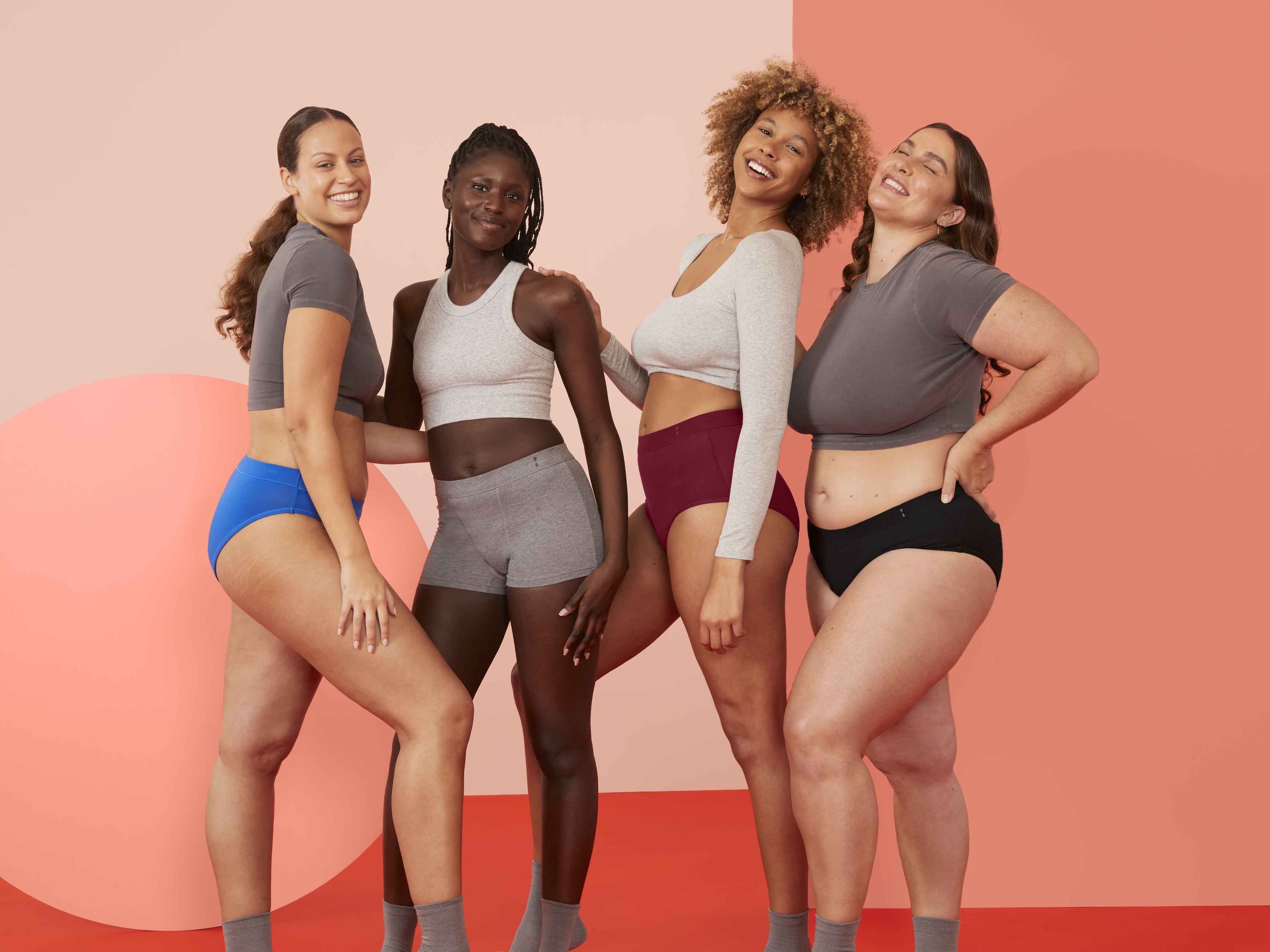An image of 4 women wearing different Thinx for All styles. The styles are Cotton Bikini, Cotton Boyshort, Cotton Hi-Waist, and Cotton Brief.
